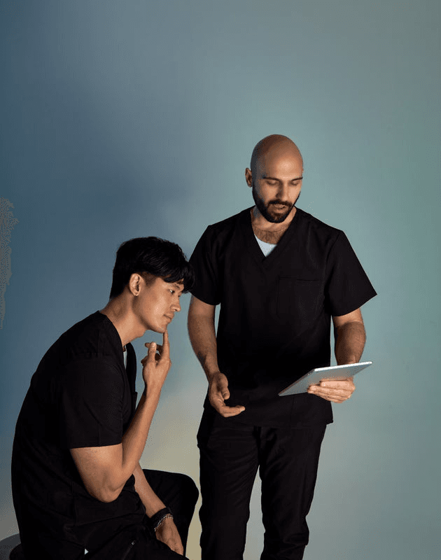 Two men looking at a tablet.