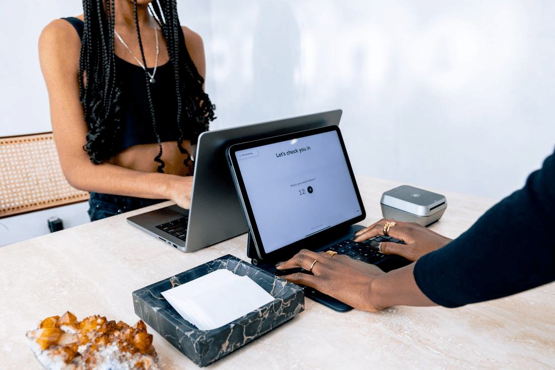 A front-desk employee checks in a client.