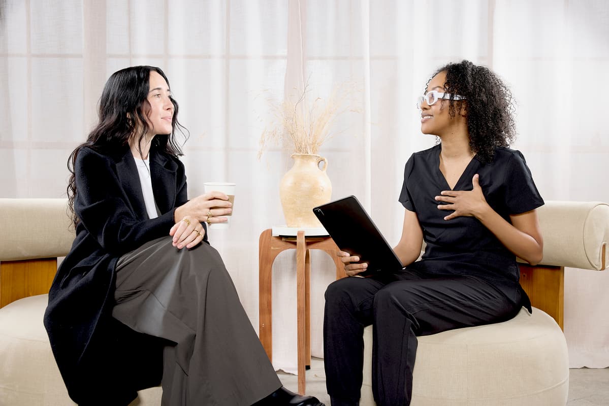 A medspa patient and a medspa employee sitting down to discuss treatment options.