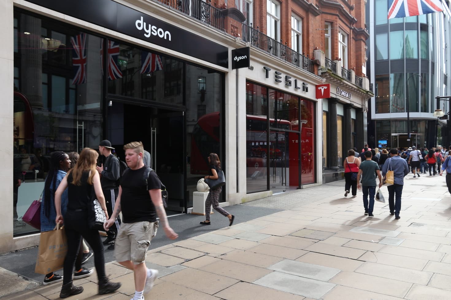 People on the street walk past a Dyson storefront
